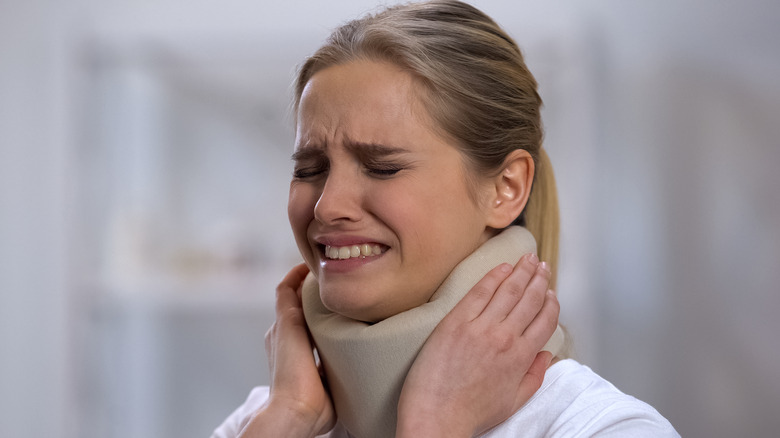 woman in pain with cervical collar on neck
