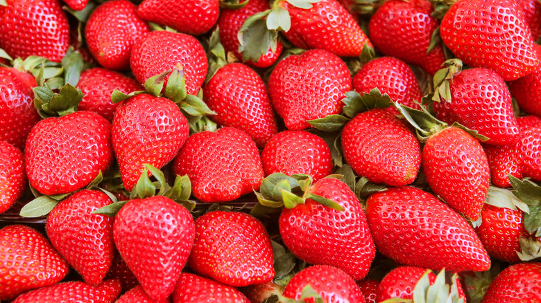 A large pile of strawberries