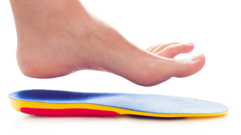 foot suspended above insole
