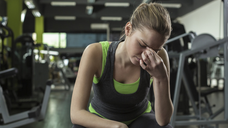tired woman on gym machine