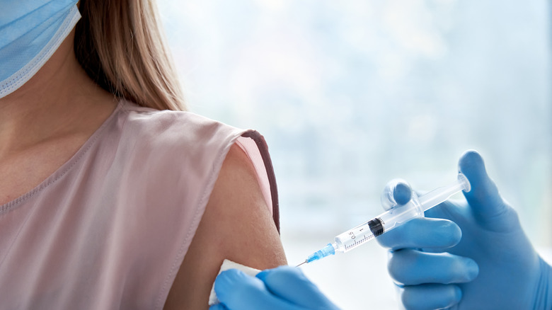 person getting vaccine in arm 
