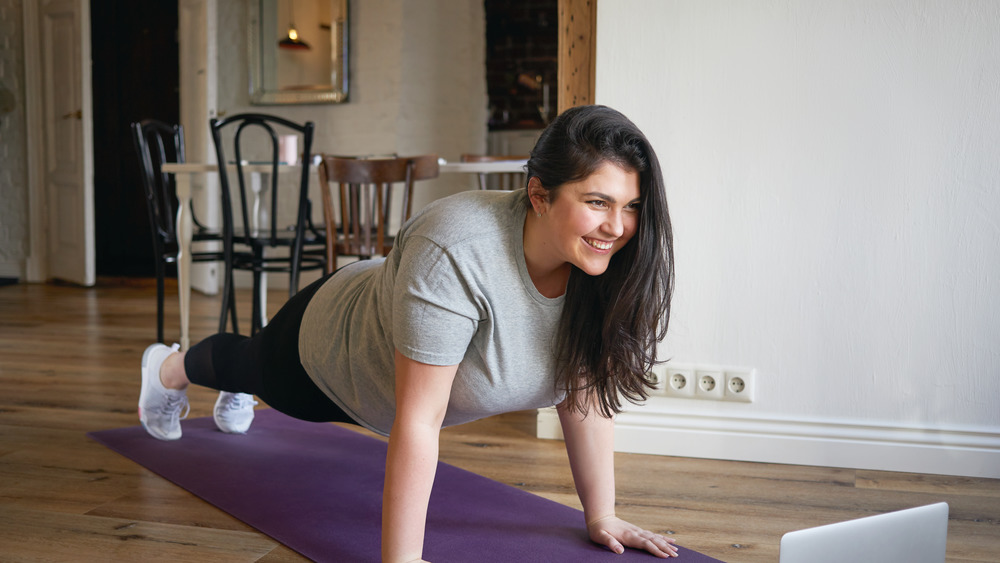 woman doing a plank at home