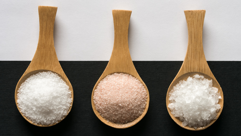 three types of salt on wooden spoons
