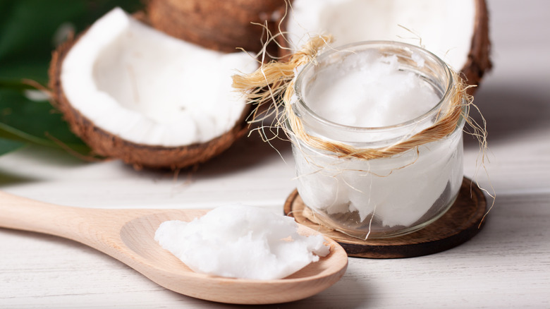 coconut oil and coconut with a wooden spoon