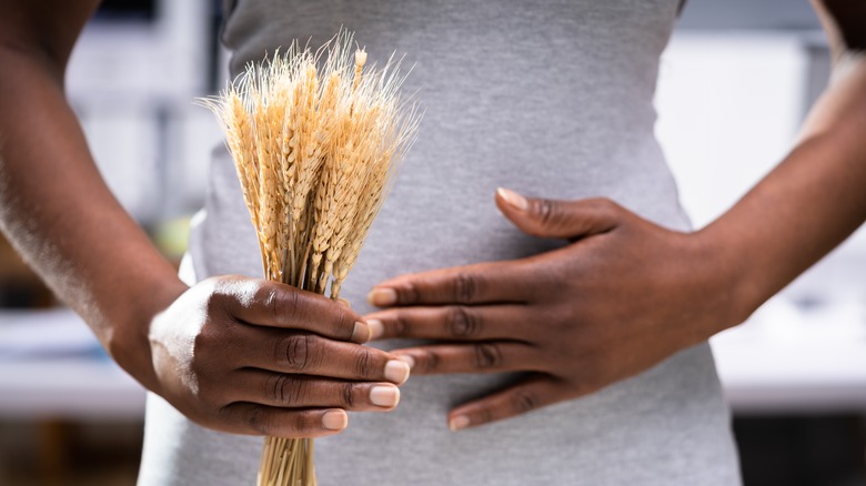person holding wheat and stomach
