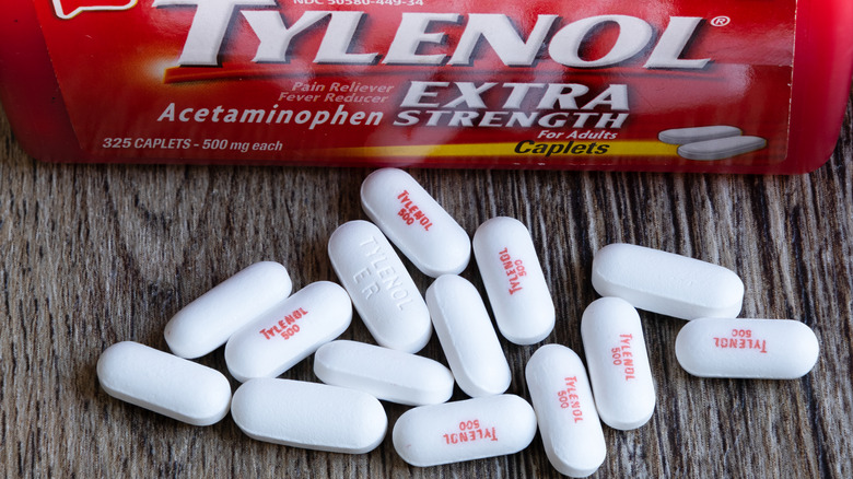 Tylenol package surrounded by pills