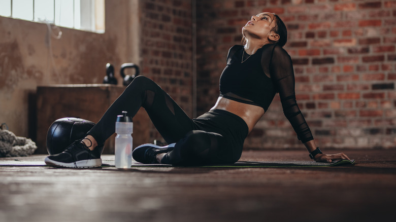 Fit woman feeling exhausted after a challenging workout