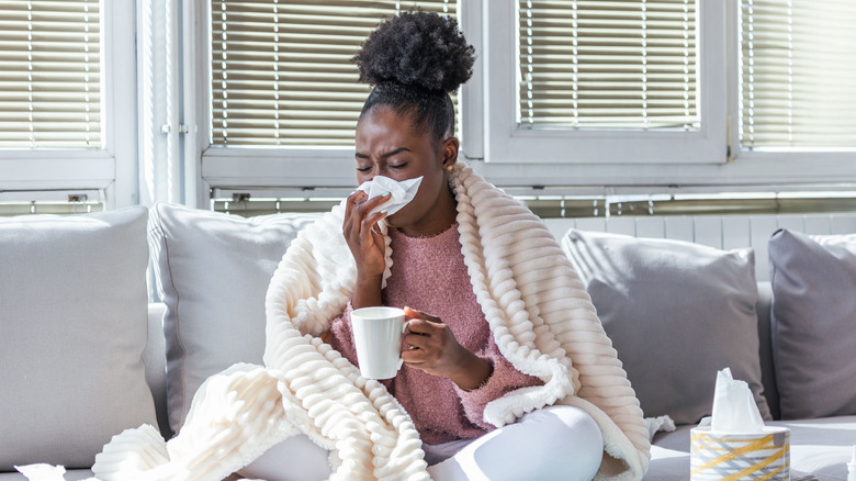 A woman has a cold at home
