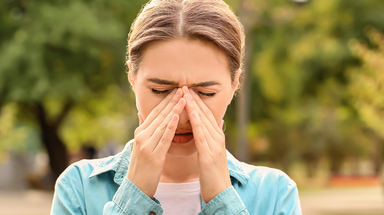 A woman experiencing seasonal allergies