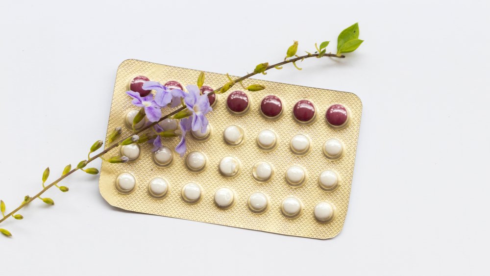 Pack of birth control pills with purple flower