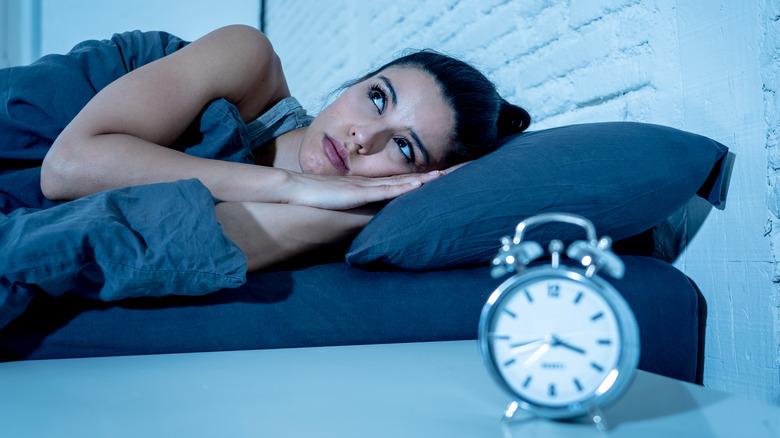 woman with insomnia awake in bed