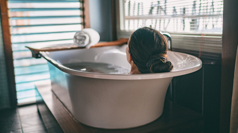 Woman soaking in bath tub