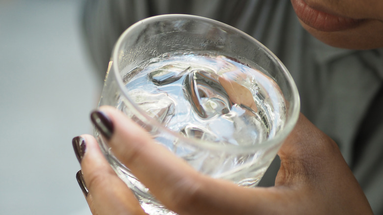 woman holding ice water