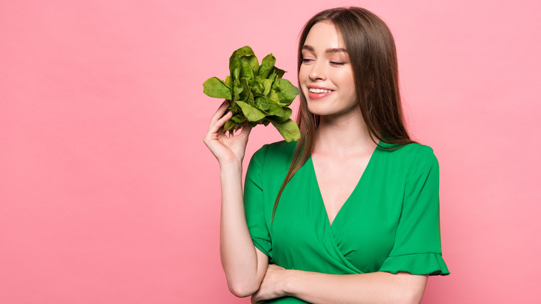 woman holding spinach