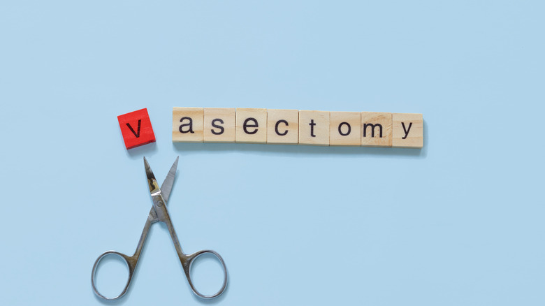scrabble tiles spelling out 'vasectomy' with miniature scissors