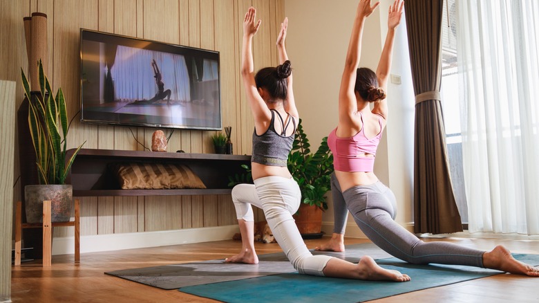 Woman and girl performing yoga poses