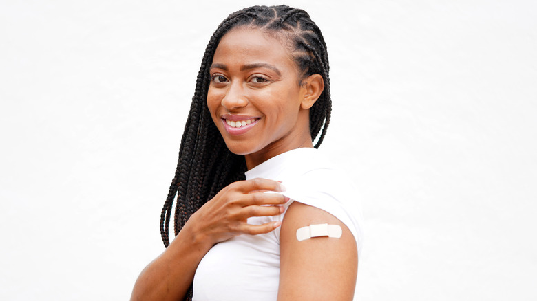 woman showing off upper arm band-aid