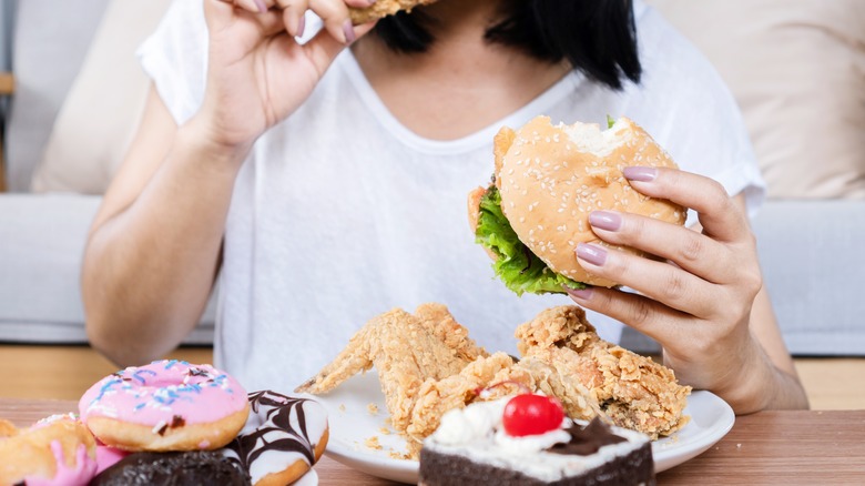 Woman eating high-fat, high-sugar food
