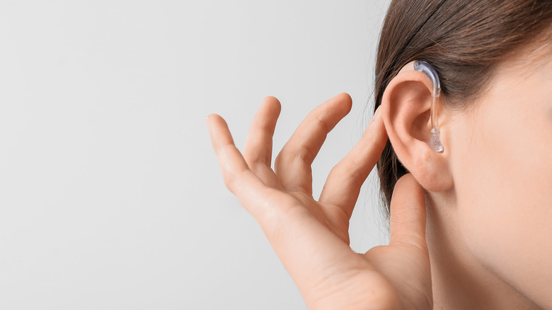 woman with hearing aid in ear