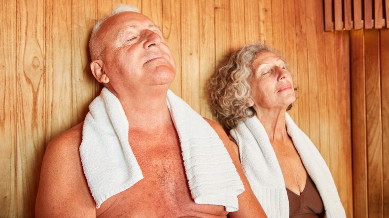 Man and woman sitting in sauna