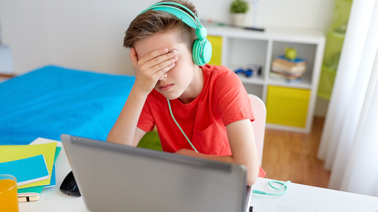 Frustrated boy playing video game