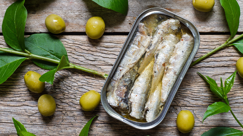 A can of sardines on a rustic table