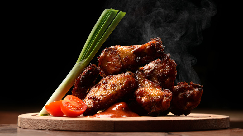 Spicy chicken wings on a plate with celery