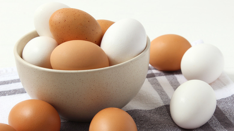 white and brown eggs in a bowl 