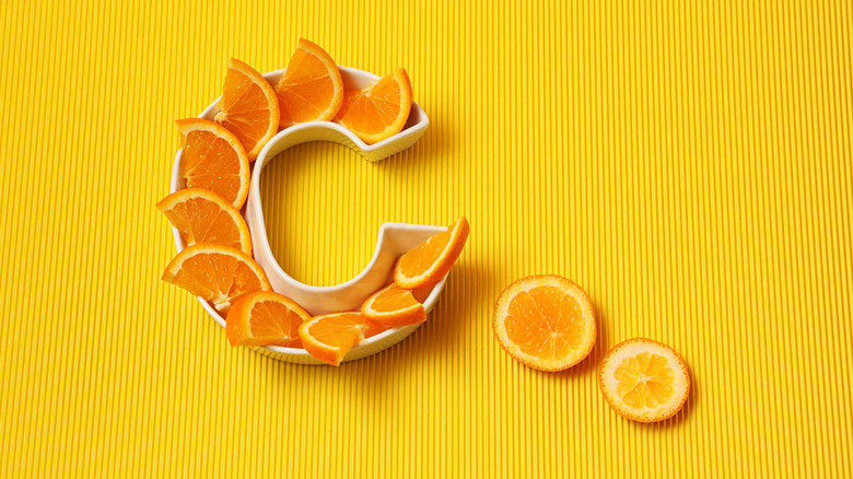 Orange slices in a C formation yellow background