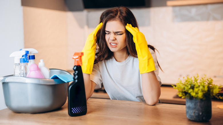 woman gets headache while cleaning