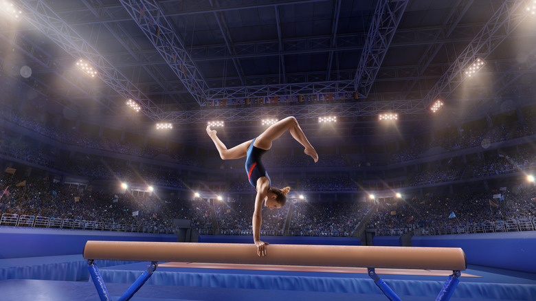 A female gymnast competes on the balance beam