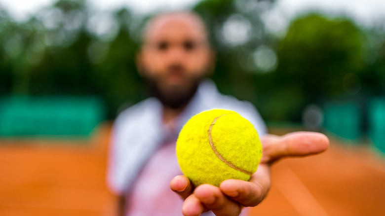 man holding a tennis ball