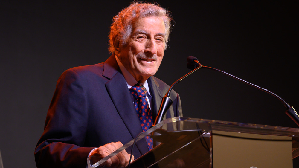 Tony Bennett standing at a lectern