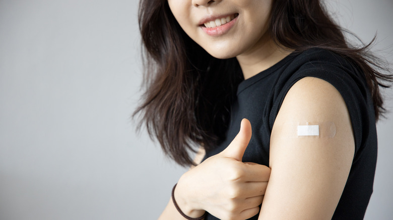 woman with bandaid on arm