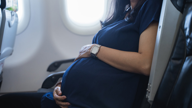 Pregnant person on plane