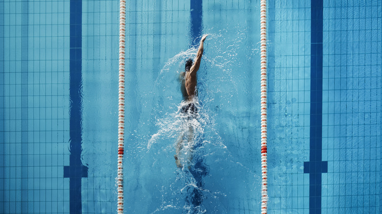 A man swims in a pool