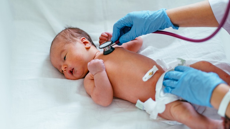 Newborn being checked by doctor in hospital