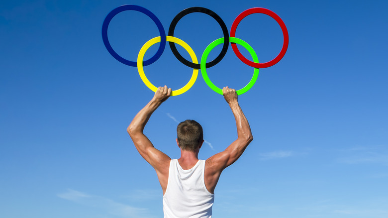 Man holding Olympic rings