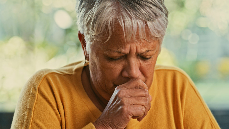 Older woman coughing
