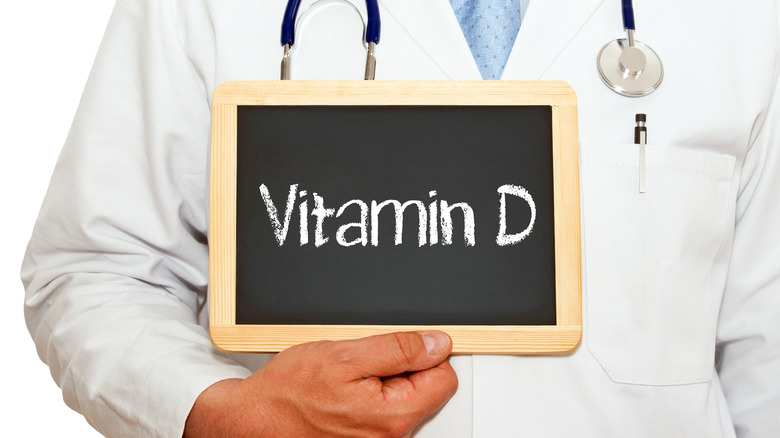 doctor holding vitamin D sign