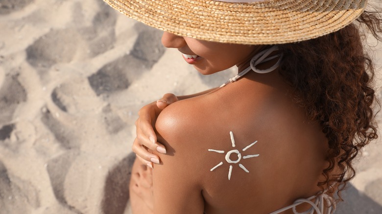 woman with sunscreen on back