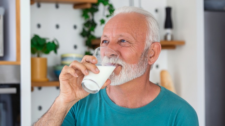 senior man drinking a glass of milk