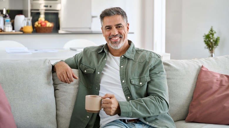 Smiling middle-aged man holding mug
