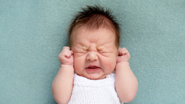 Irritable infant in pain from teething 