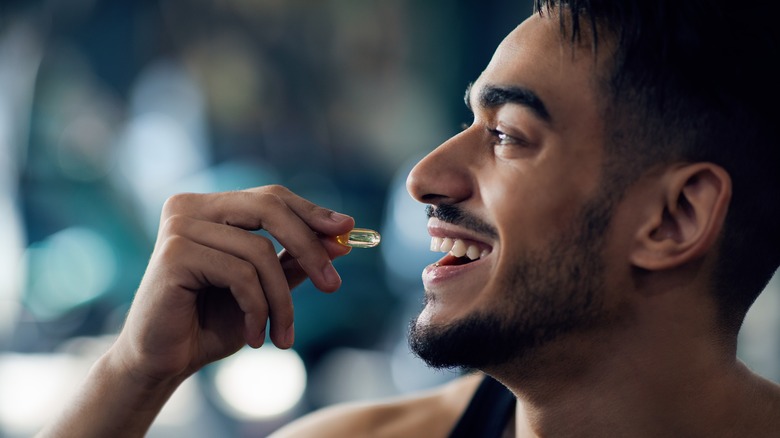 Profile of man taking a supplement