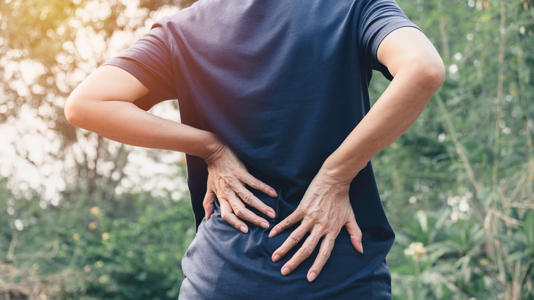 A woman has back pain
