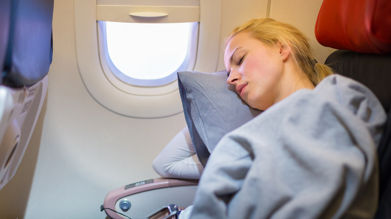 Woman asleep in airplane seat