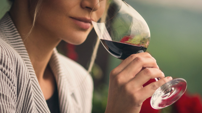 woman sniffing a glass of red wine