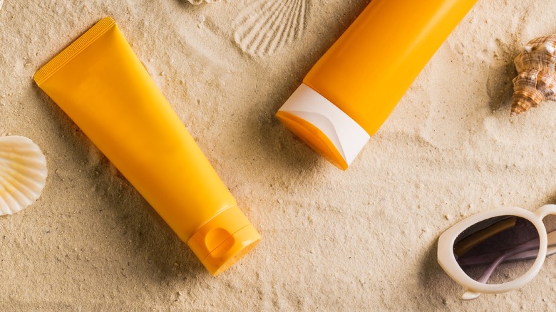 sunscreen bottles on a beach