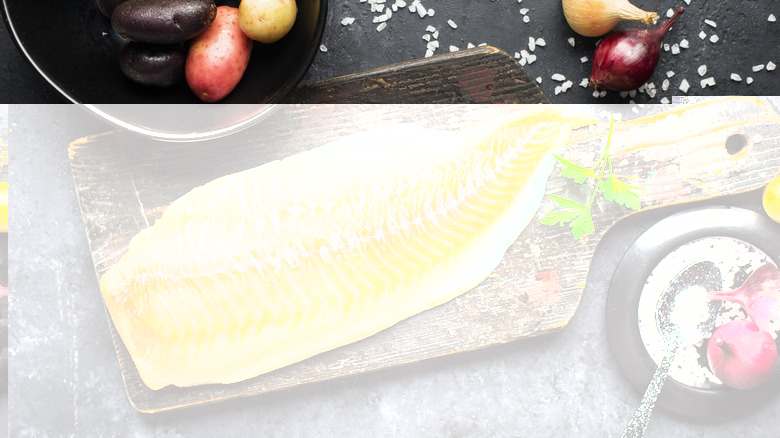 A cod fillet on a cutting board